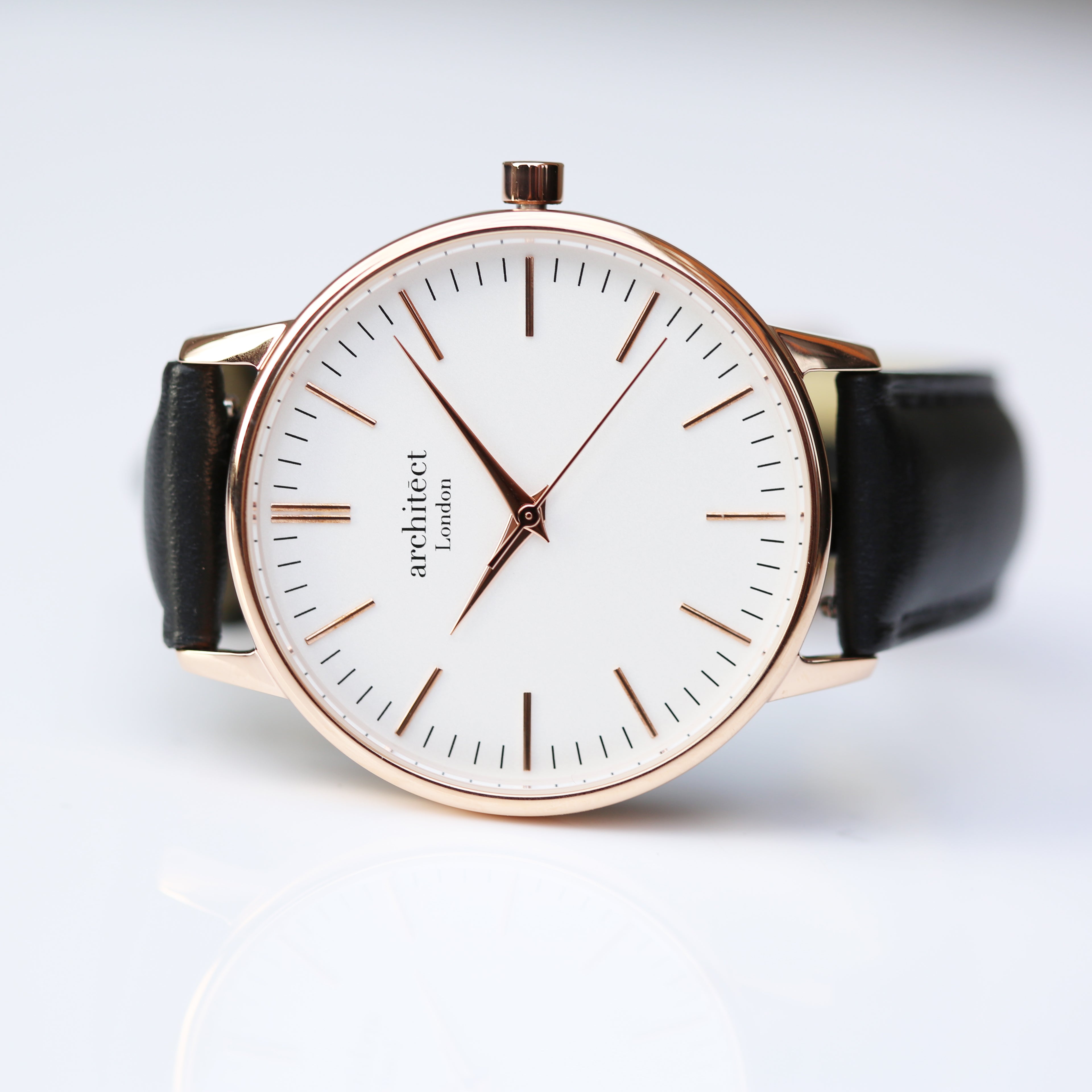 Minimalist ladies Blanc watch with rose gold case, white dial and black strap