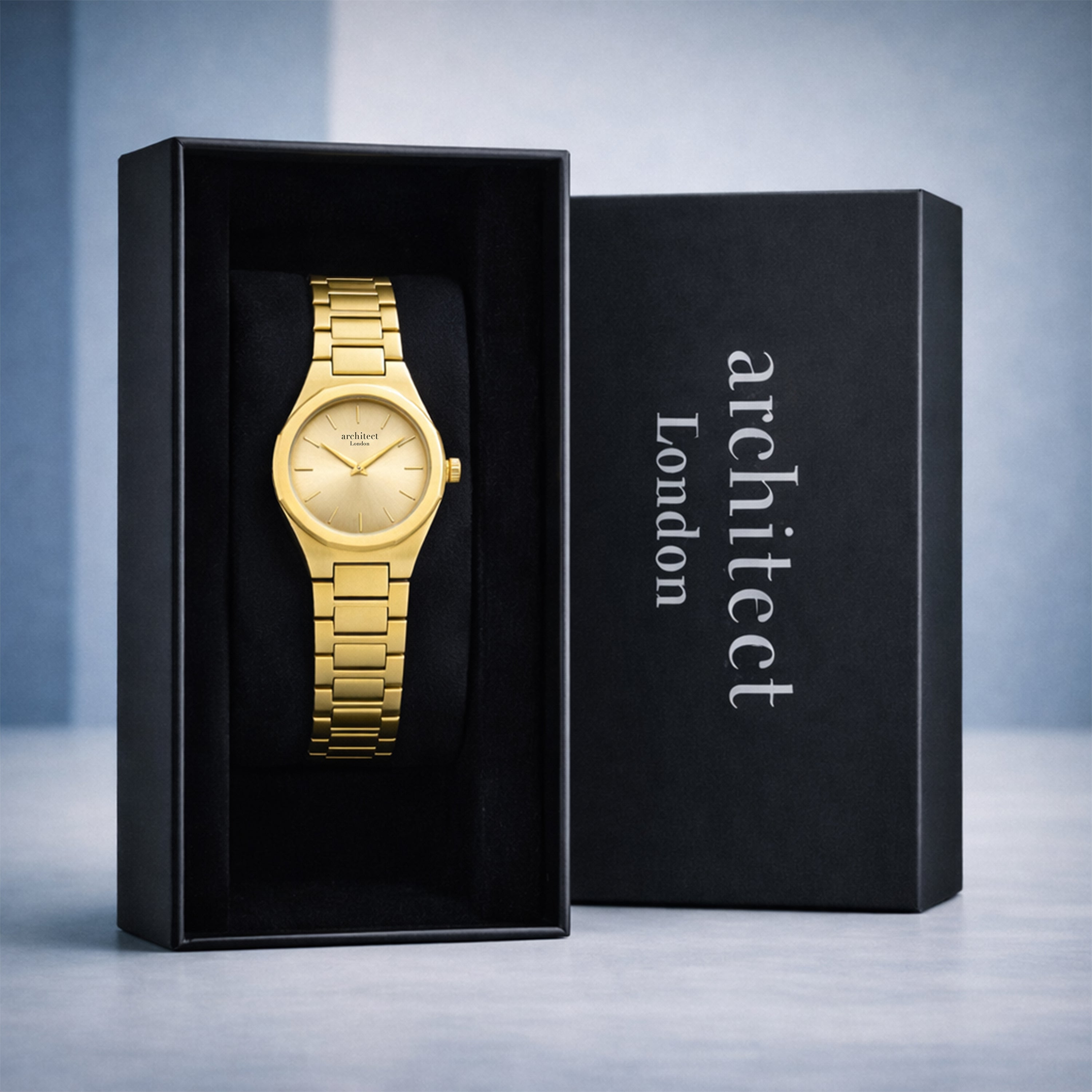Ladies gold watch in a black box with 'architect London' branding on a gray background
